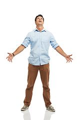 Image showing Seriously. A young man looking to the skies with his arms open - isolated.