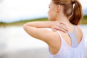 Image showing This is so painful. Rearview shot of a young woman touching her shoulder.