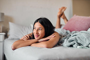 Image showing Daydreams give us something to look forward to. Shot of a young woman enjoying a relaxing moment in bed at home.
