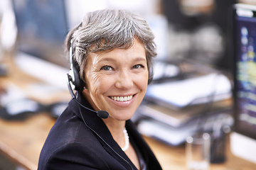 Image showing Her clients enjoy her friendly demeanor. Shot of an mature female call center representative wearing a headset.