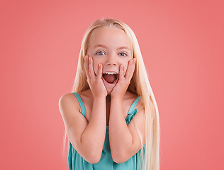 Image showing Look at that.... Studio shot of a young girl posing on an orange background.