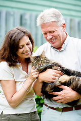 Image showing Hes like a member of the family. Cropped shot of a senior couple with their cat outdoors.