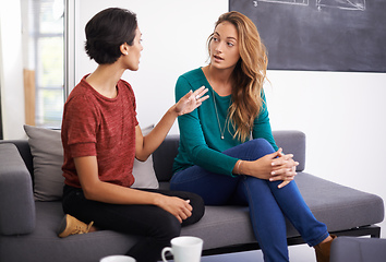 Image showing Theyre working together on an exciting project. Shot of two female professionals having a discussion in an informal office setting.