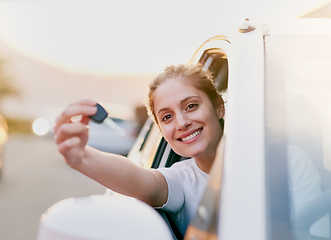 Image showing Lets hit the road. Portrait of a young woman holding the keys to her car while sitting inside it.