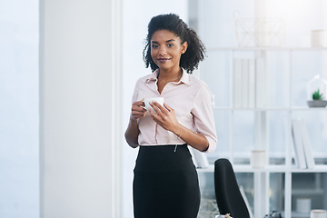 Image showing Taking a quick break before heading back to work. Portrait of a young businesswoman drinking a cup of coffee in an office.