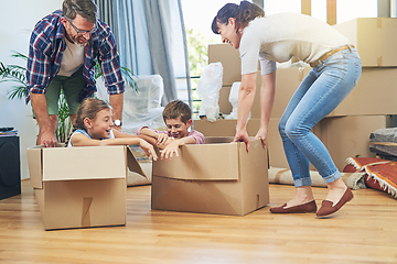 Image showing Making moving day a family friendly activity. Shot of a happy family having fun together on moving day.