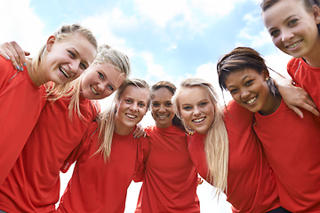 Image showing We are ready to win. Portrait of an all-girls soccer team standing arm in arm outside.