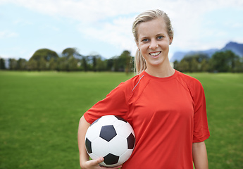 Image showing In it to win. Shot of a young female soccer player holding a soccer ball.