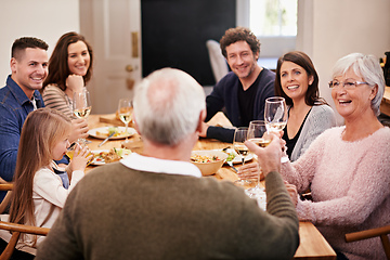 Image showing Id like to say a few words.... Cropped shot of a family sitting down to dinner.