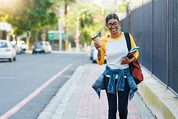 Image showing Got my coffee to commute to college. Cropped shot of a young female student commuting to college in the city.