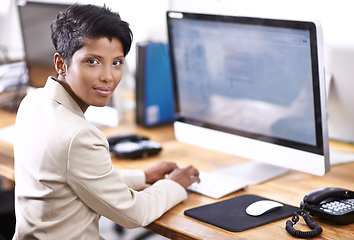 Image showing Shes a very diligent worker. Portrait of an attractive businesswoman working on a desktop computer.