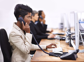 Image showing Pushing hard to reach their targets. Shot of three businesswomen working in an office.