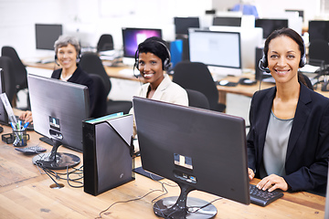 Image showing Theyre the best team in the call center. Cropped shot of three female call center representatives wearing headsets.