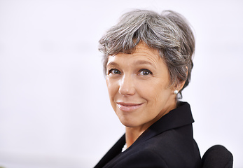 Image showing Its good to be the boss. Portrait of a mature businesswoman sitting indoors.