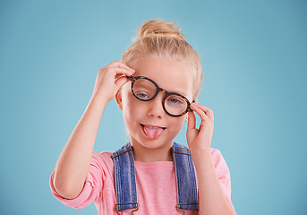 Image showing These glasses are so funny. Studio shot of a little girl wearing hipster glasses on a blue background.