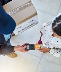 Image showing For your convenience. High angle shot of an unrecognizable delivery man receiving payment from a female customer for her order.