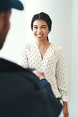 Image showing Great service will always leave a smile on your face. Shot of an unrecognizable male courier shaking hands with a female customer.