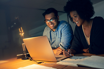 Image showing They always perform at their peak no matter the hour. Cropped shot of two colleagues working late on a laptop in an office.