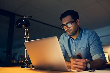 Image showing Focused on achieving only the best. Cropped shot of a young businessman working late on a laptop in an office.
