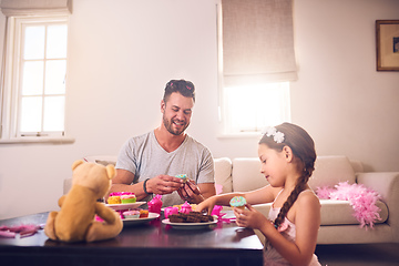 Image showing Dad will do anything to make her feel like a princess. Shot of a father and his little daughter having a tea party together at home.