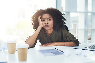 Image showing Running out of ideas is normal, just never give up. Portrait of a young businesswoman sitting at her office desk looking tired and stressed out.