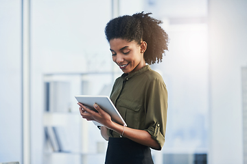 Image showing Life made easier with the touch of a button. Shot of a young businesswoman using her digital tablet in a office.