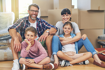 Image showing Home - a place of love and happiness. Portrait of a happy family spending time together in their home on moving day.