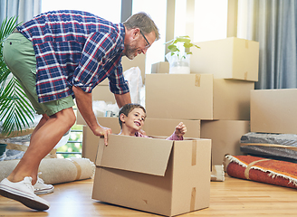 Image showing Filling every room with fun memories. Shot of a happy father and son having fun together on moving day.