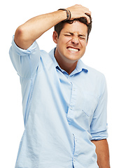 Image showing Suffering from self loathing. A handsome young man holding his head in pain against a white background.