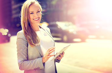 Image showing Navigating city life. Portrait of an attractive woman using a digital tablet while walking in the city.