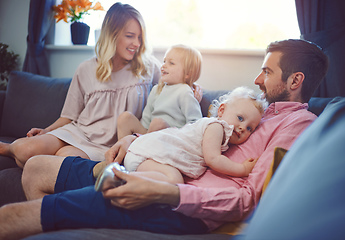 Image showing Make time for those you love. Shot of an adorable young family of four relaxing together on the sofa at home.