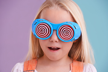 Image showing Going crazeeee. A cute little girl wearing funny sunglasses against a colorful background.