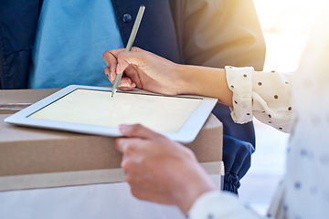 Image showing Making deliveries even more convenient. Cropped shot of an unrecognizable delivery man getting a signature from a female customer for her order.