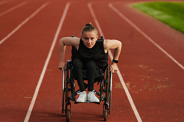 Image showing A woman with disablity driving a wheelchair on a track while preparing for the Paralympic Games