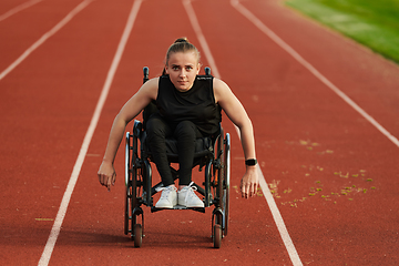 Image showing A woman with disablity driving a wheelchair on a track while preparing for the Paralympic Games