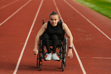 Image showing A woman with disablity driving a wheelchair on a track while preparing for the Paralympic Games