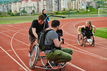 Image showing A cameraman filming the participants of the Paralympic race on the marathon course