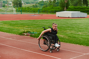 Image showing A woman with disablity driving a wheelchair on a track while preparing for the Paralympic Games