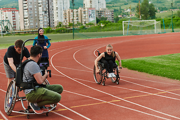 Image showing A cameraman filming the participants of the Paralympic race on the marathon course