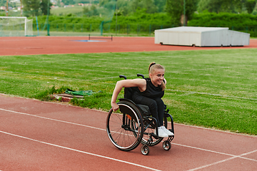 Image showing A woman with disablity driving a wheelchair on a track while preparing for the Paralympic Games