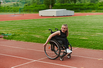 Image showing A woman with disablity driving a wheelchair on a track while preparing for the Paralympic Games