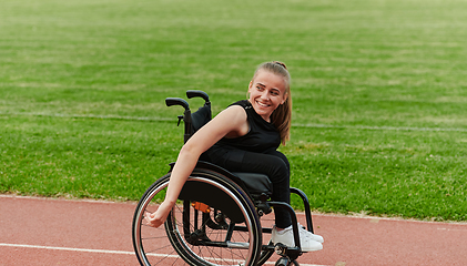 Image showing A woman with disablity driving a wheelchair on a track while preparing for the Paralympic Games