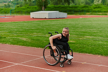 Image showing A woman with disablity driving a wheelchair on a track while preparing for the Paralympic Games