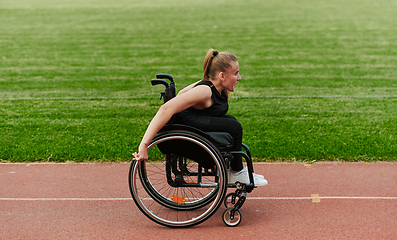 Image showing A woman with disablity driving a wheelchair on a track while preparing for the Paralympic Games