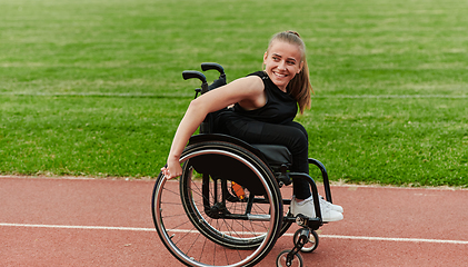 Image showing A woman with disablity driving a wheelchair on a track while preparing for the Paralympic Games