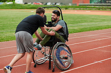 Image showing A cameraman filming the participants of the Paralympic race on the marathon course