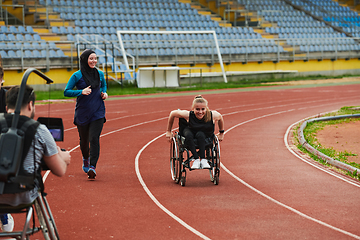 Image showing A cameraman filming the participants of the Paralympic race on the marathon course