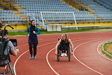 Image showing A cameraman filming the participants of the Paralympic race on the marathon course