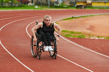 Image showing A woman with disablity driving a wheelchair on a track while preparing for the Paralympic Games