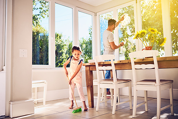 Image showing Helping Dad with some spring cleaning around the house. Shot of a father and his little daughter doing chores together at home.